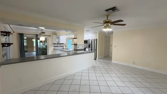 a view of a kitchen with a sink and cabinets