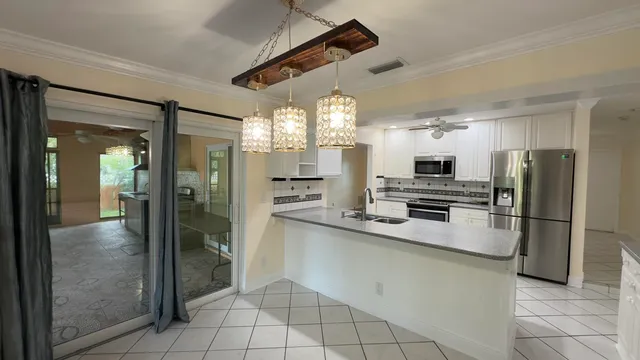 a kitchen with stainless steel appliances granite countertop a refrigerator and a sink