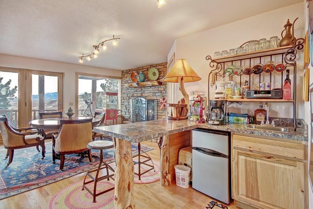 1092 Sheep Ridge Road Fairplay, CO 80440 - Photo 22 of 25 a open kitchen with stainless steel appliances granite countertop a stove top oven a sink a dining table and chairs with wooden floor