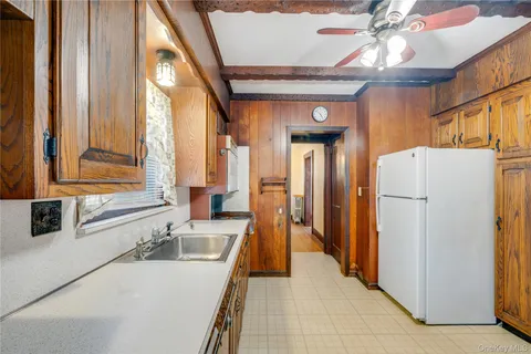 a kitchen with a refrigerator a sink and a large window