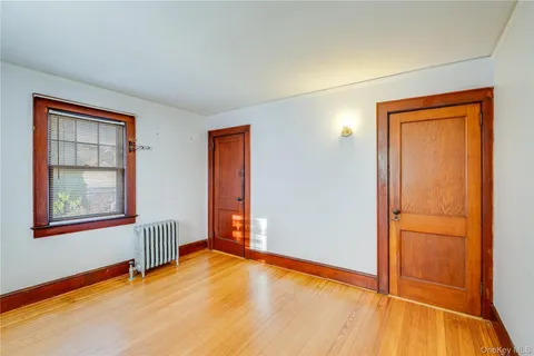 an empty room with windows and closet