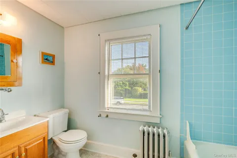 a white toilet sitting next to a bathroom sink