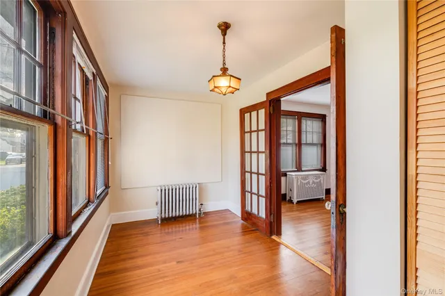 a view of a hallway with wooden floor and stairs