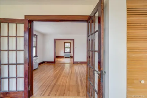 a view of a hallway with wooden floor and staircase