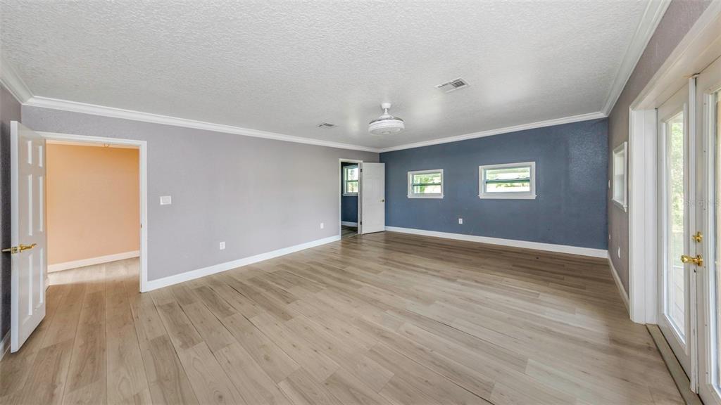 20138 Bowman Road Spring Hill, FL 34610 - Photo 26 of 40 a view of an empty room with wooden floor and a window