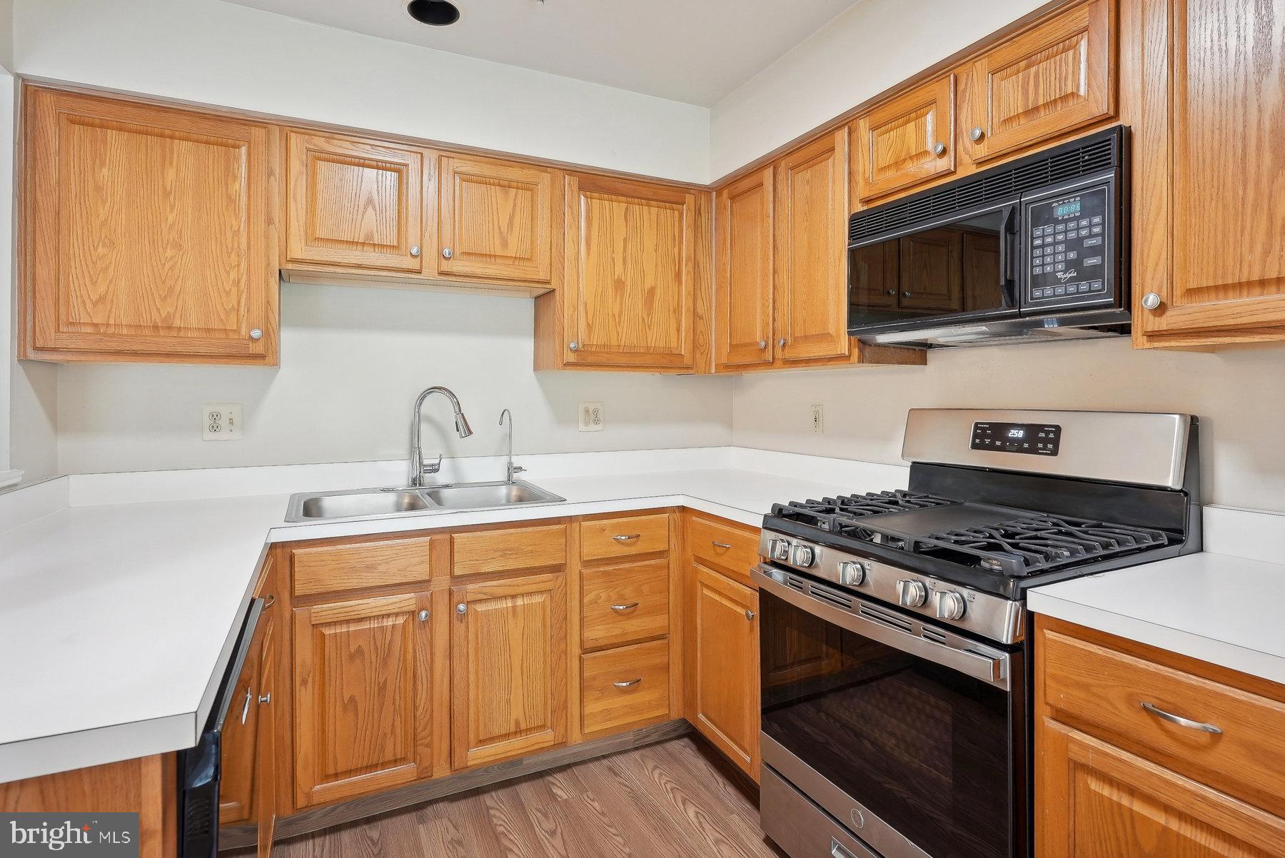 624 Brickhouse Road Princeton, NJ 08540 - Photo 11 of 35 a kitchen with stainless steel appliances granite countertop a sink stove oven a sink dishwasher and cabinets with wooden floor