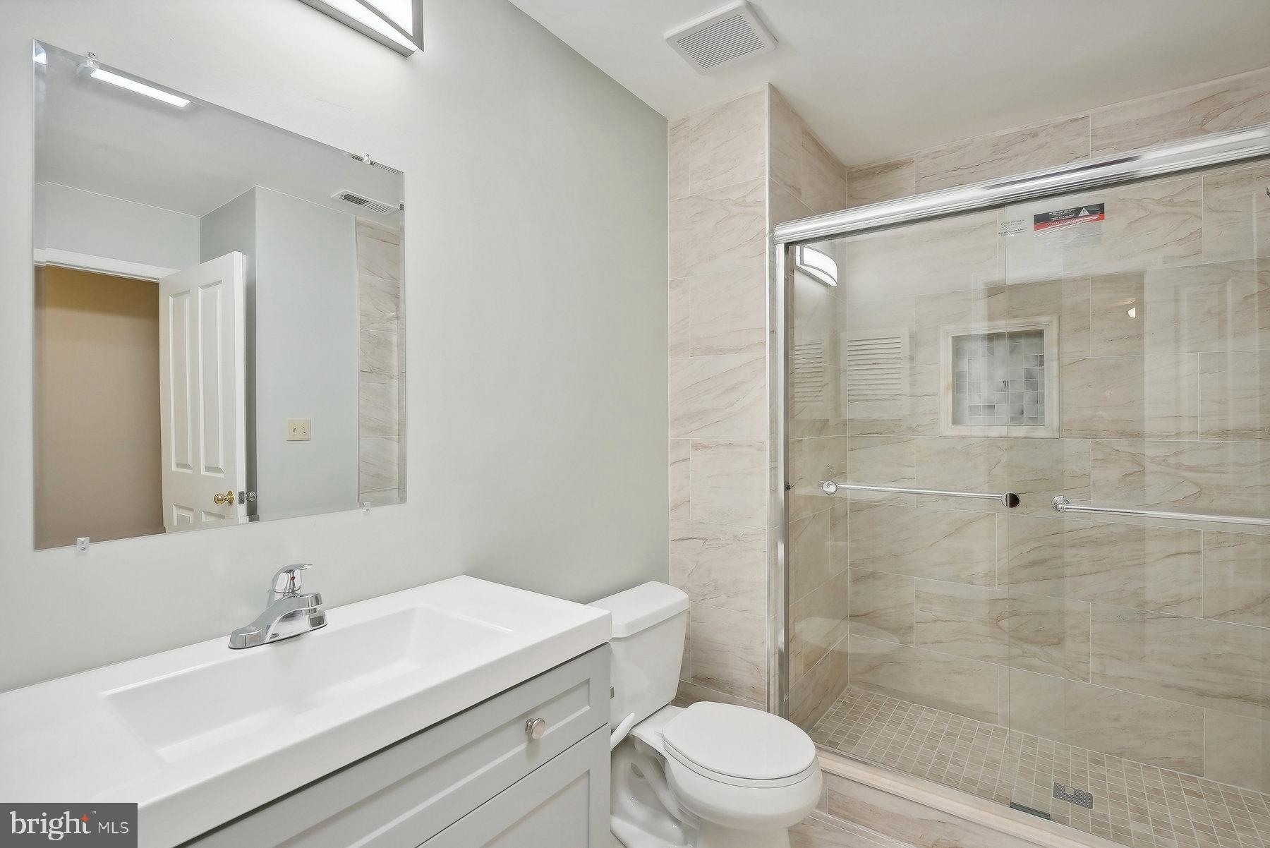 624 Brickhouse Road Princeton, NJ 08540 - Photo 14 of 35 a bathroom with a sink mirror toilet and shower