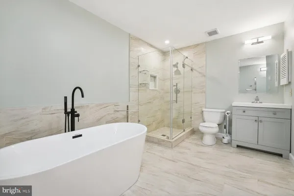 a bathroom with a double vanity sink toilet and shower
