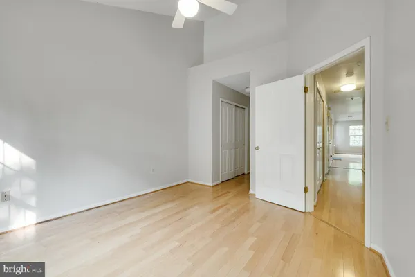a view of empty room with wooden floor