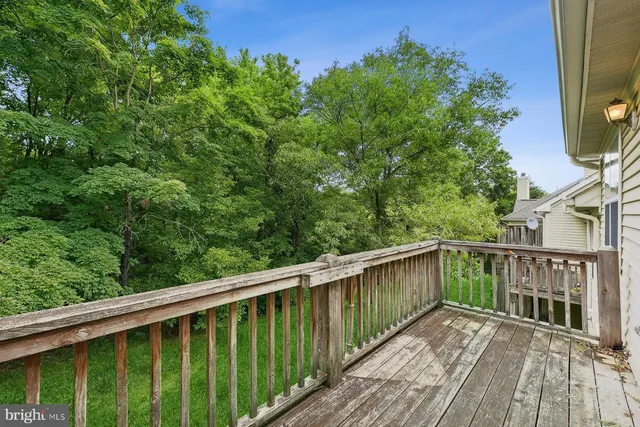 a balcony with wooden floor and fence