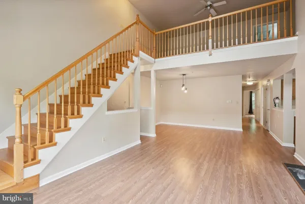 a view of staircase with railing and white walls