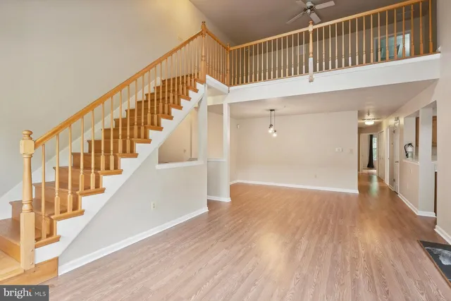 a view of staircase with railing and white walls