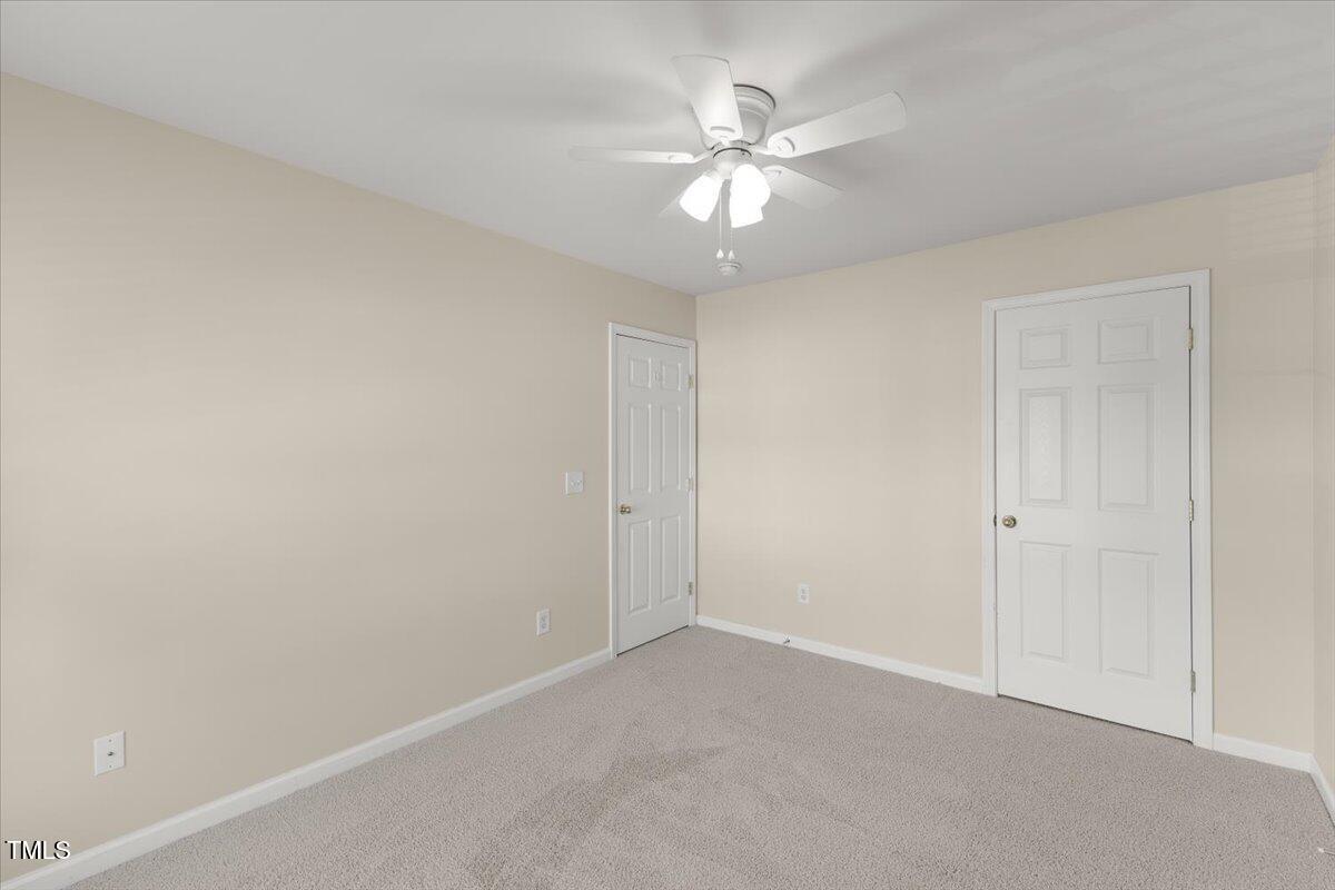 8123 Rhiannon Road Raleigh, NC 27613 - Photo 31 of 47 an empty room with a chandelier fan