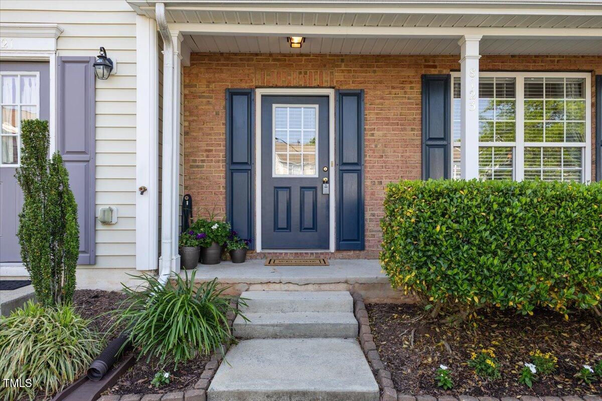 8123 Rhiannon Road Raleigh, NC 27613 - Photo 6 of 47 a front view of a house with a yard