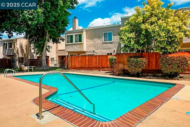 a view of a backyard with swimming pool