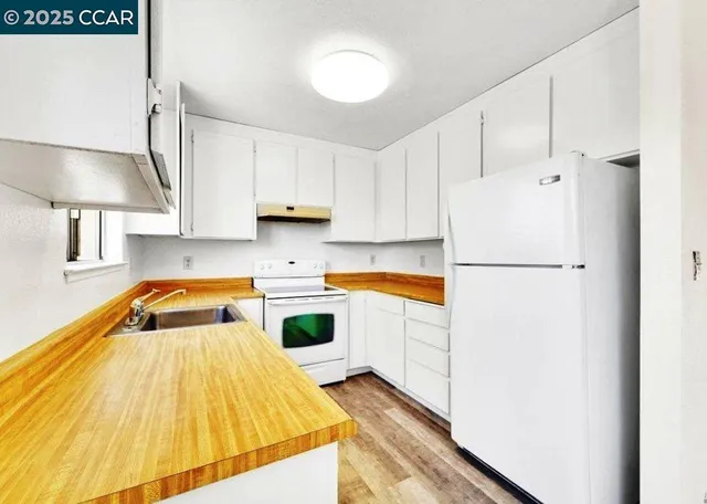 a kitchen with a refrigerator and a stove