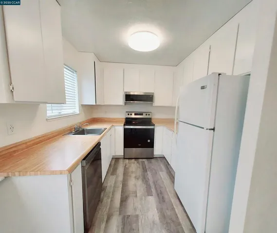 a kitchen with a refrigerator a sink and dishwasher