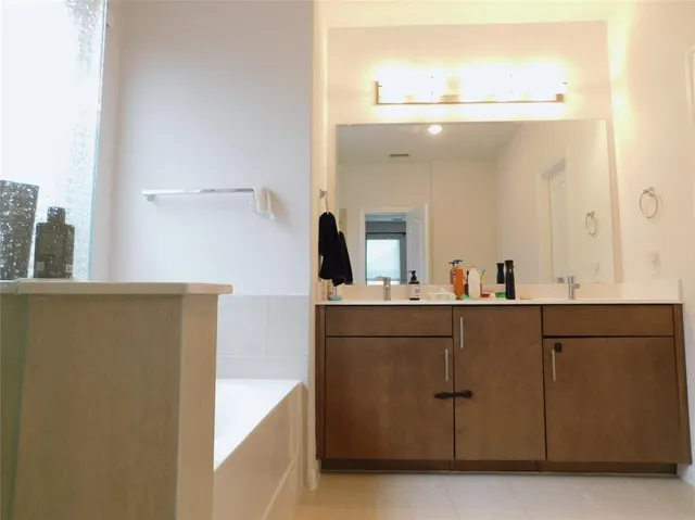 a bathroom with a sink and mirror