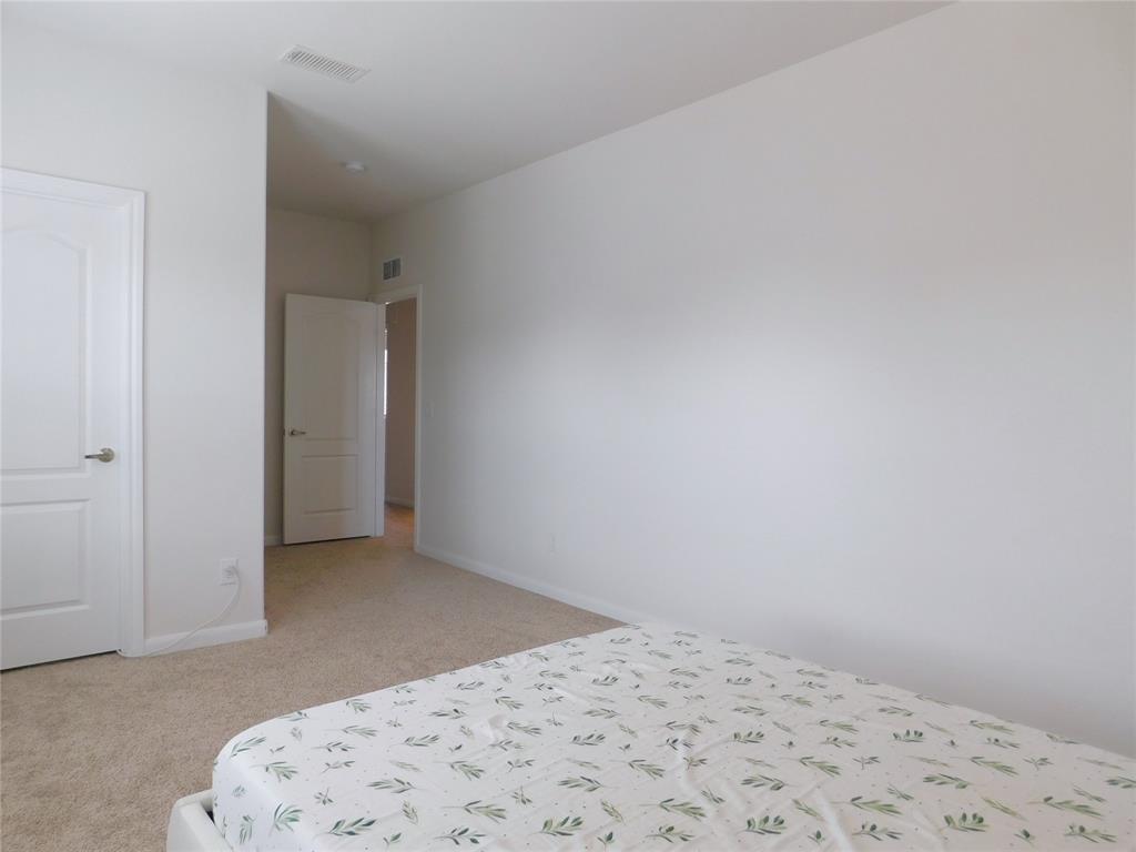 1111 Saddle Ridge Drive Aubrey, TX 76227 - Photo 22 of 35 a bedroom with a bed and a window