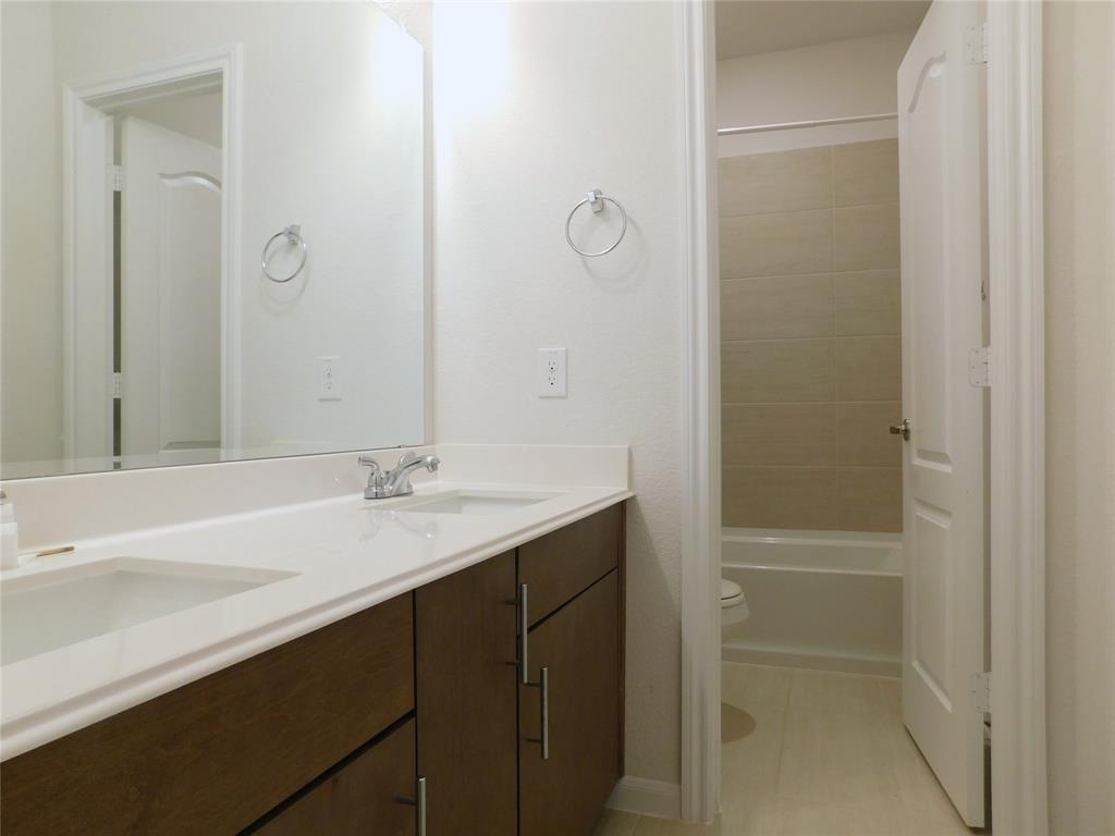 1111 Saddle Ridge Drive Aubrey, TX 76227 - Photo 28 of 35 a bathroom with a sink and a mirror