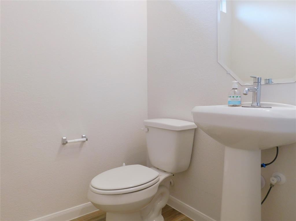 1111 Saddle Ridge Drive Aubrey, TX 76227 - Photo 30 of 35 a bathroom with a sink toilet and a mirror