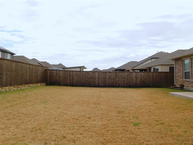 a view of a house with swimming pool and a yard