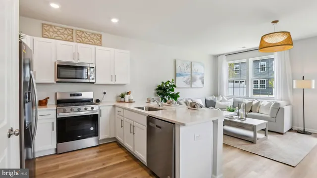 a kitchen with stainless steel appliances granite countertop a stove and a refrigerator