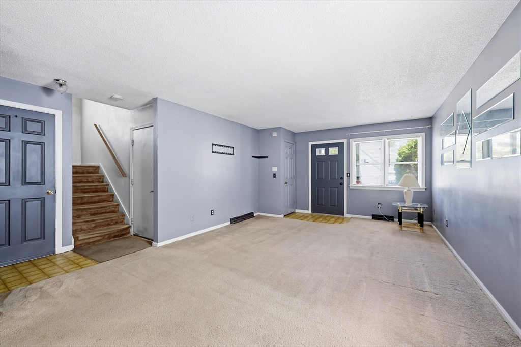 19-21 Wedgewood Circle Springfield, MA 01129 - Photo 9 of 32 a view of an empty room with stairs and a window