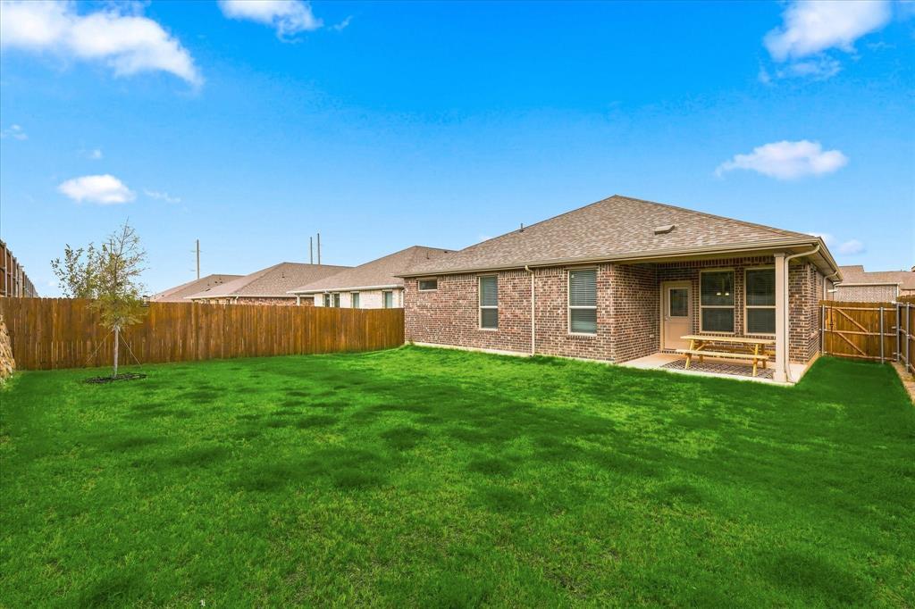141 Medina Lane Rhome, TX 76078 - Photo 30 of 36 Brick exterior with an attached covered patio featuring a concrete surface