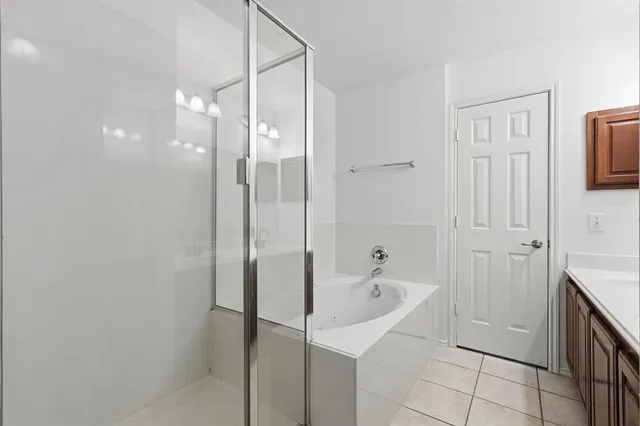 a bathroom with a bathtub and a shower