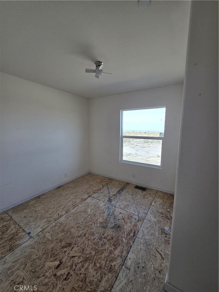 12474 Silver Rock Road Pinon Hills, CA 92372 - Photo 13 of 34 an empty room with a empty space and windows