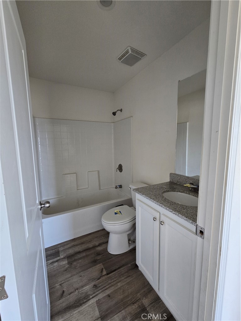 12474 Silver Rock Road Pinon Hills, CA 92372 - Photo 14 of 34 a bathroom with a granite countertop toilet a sink and a bathtub