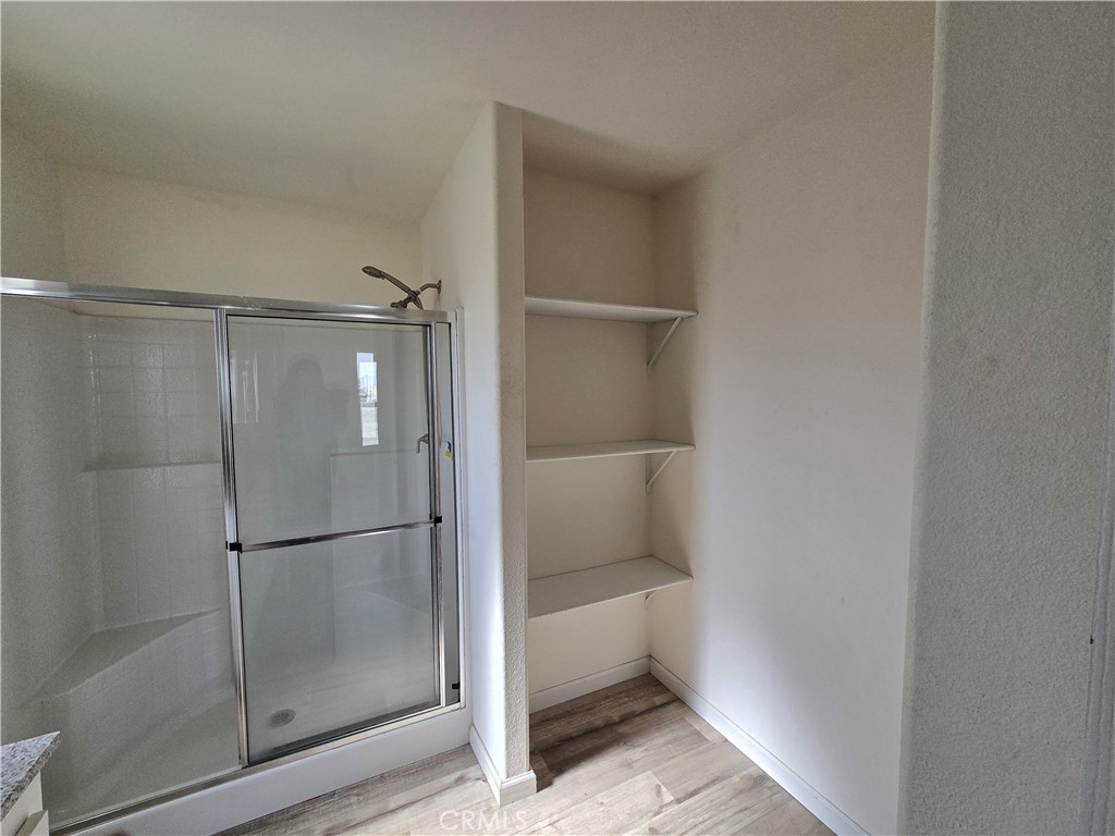12474 Silver Rock Road Pinon Hills, CA 92372 - Photo 16 of 34 a bathroom with a glass shower door