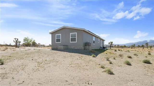 a front view of a house with a yard covered in snow