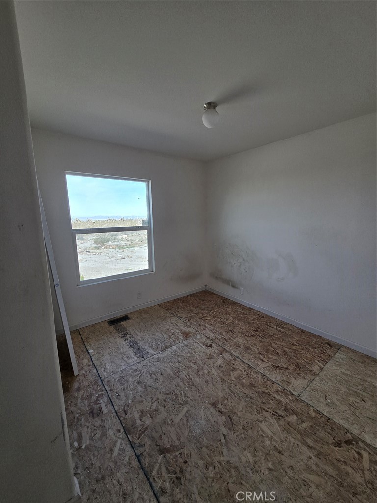 12474 Silver Rock Road Pinon Hills, CA 92372 - Photo 22 of 34 an empty room with a empty space and windows