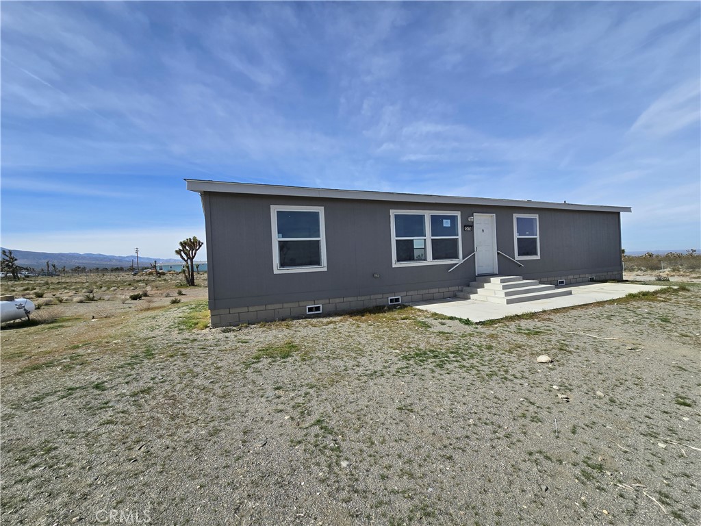 12474 Silver Rock Road Pinon Hills, CA 92372 - Photo 3 of 34 a house with trees in the background