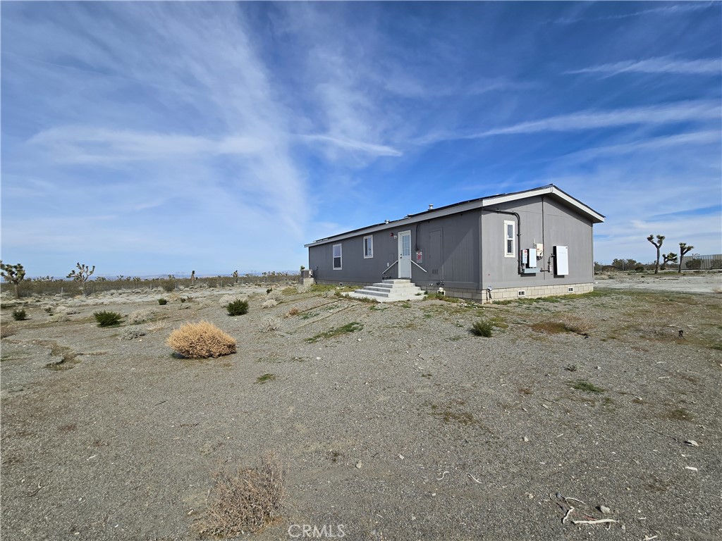 12474 Silver Rock Road Pinon Hills, CA 92372 - Photo 33 of 34 a view of a house with backyard and wooden fence