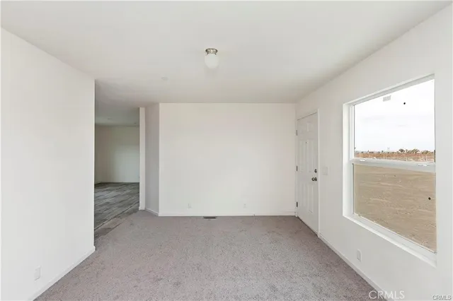 a view of a kitchen with a sink a refrigerator and window