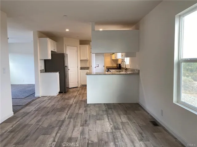 a kitchen with granite countertop a stove a sink and a granite counter tops