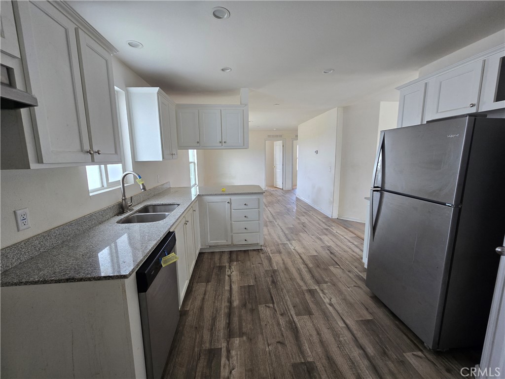 12474 Silver Rock Road Pinon Hills, CA 92372 - Photo 8 of 34 a kitchen with a wooden floor and a stove