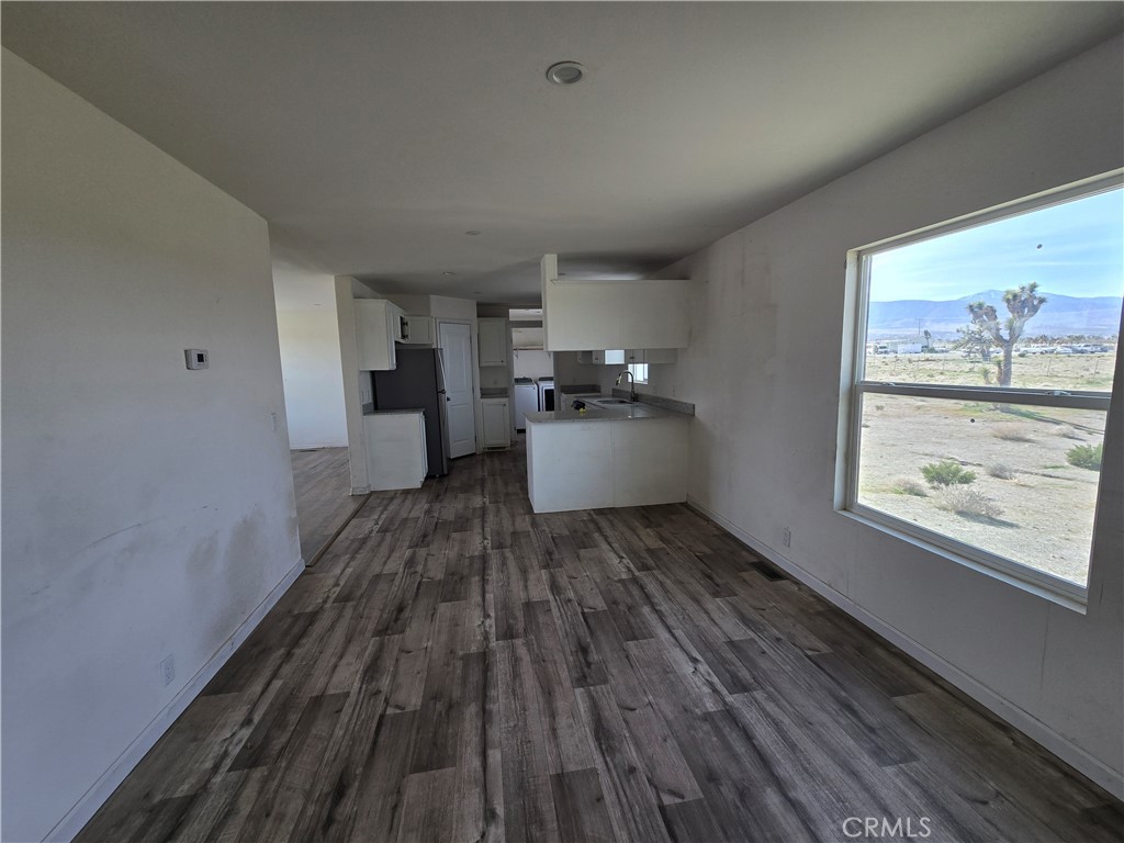 12474 Silver Rock Road Pinon Hills, CA 92372 - Photo 10 of 34 a view of a kitchen with wooden floor and window