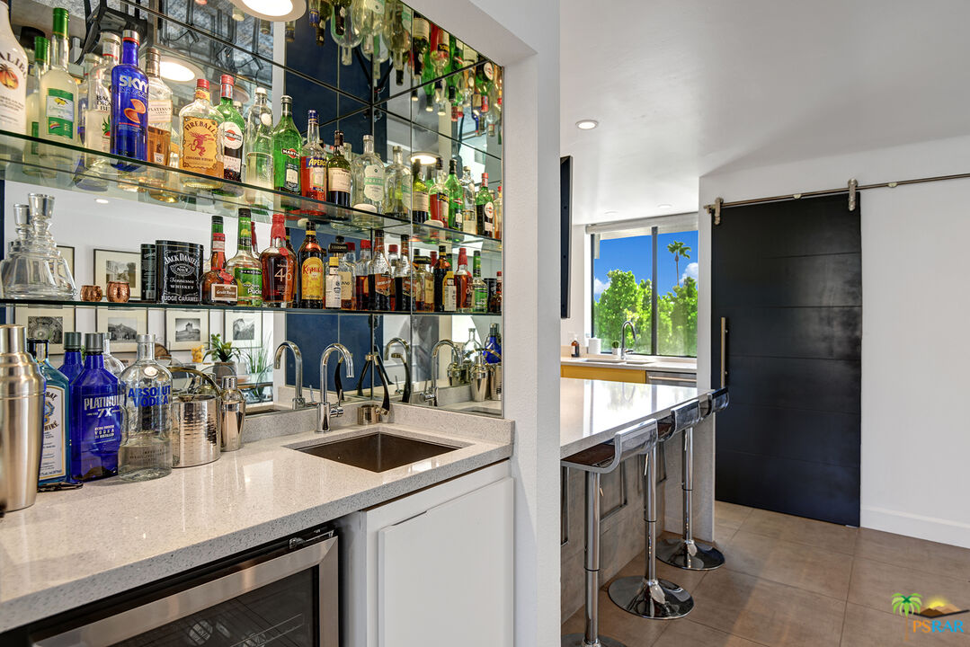 1530 North Kaweah Road Palm Springs, CA 92262 - Photo 11 of 42 a kitchen filled with a refrigerator and a sink