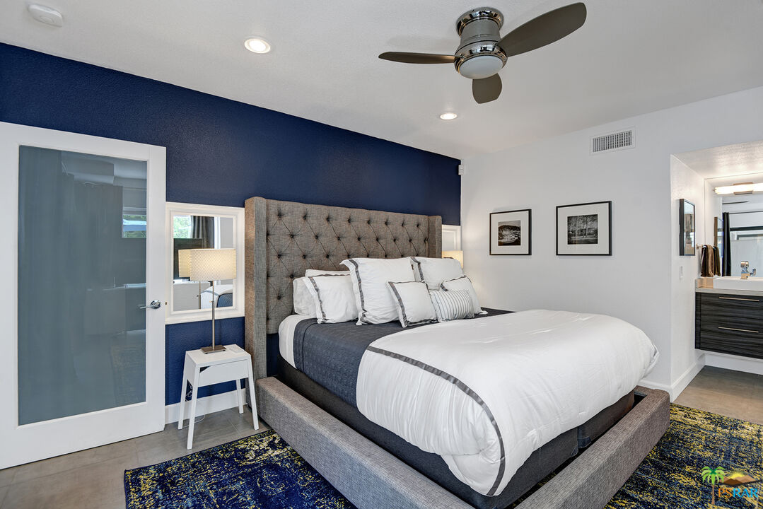 1530 North Kaweah Road Palm Springs, CA 92262 - Photo 16 of 42 a bedroom with a bed chandelier and a window
