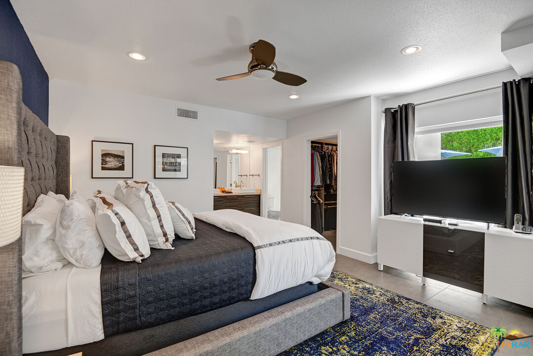 1530 North Kaweah Road Palm Springs, CA 92262 - Photo 17 of 42 a bedroom with a bed and a flat screen tv