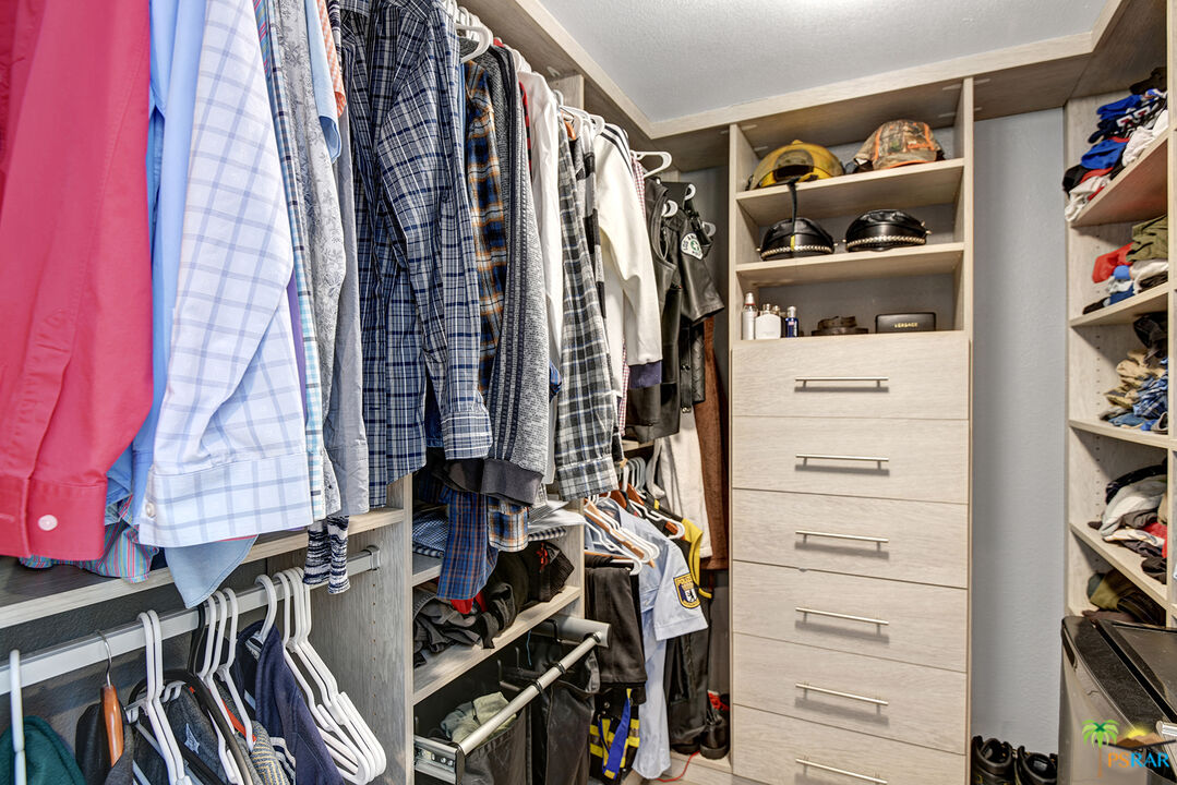 1530 North Kaweah Road Palm Springs, CA 92262 - Photo 22 of 42 a view of walk in closet with clothes and shoes