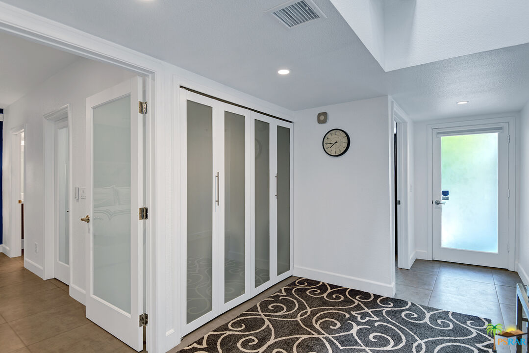 1530 North Kaweah Road Palm Springs, CA 92262 - Photo 23 of 42 a view of a hallway with wooden floor and closet