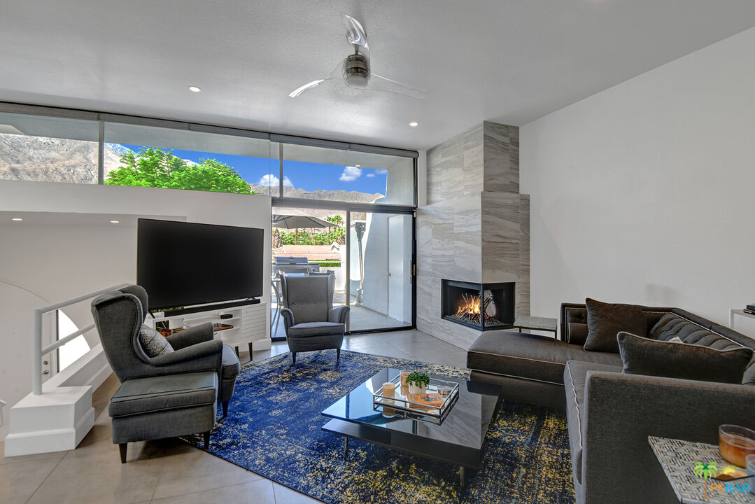 1530 North Kaweah Road Palm Springs, CA 92262 - Photo 3 of 42 a living room with furniture a flat screen tv and a fireplace