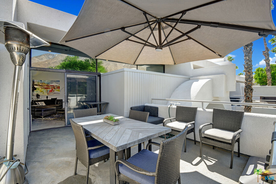 1530 North Kaweah Road Palm Springs, CA 92262 - Photo 33 of 42 a outdoor dining space with furniture and umbrella