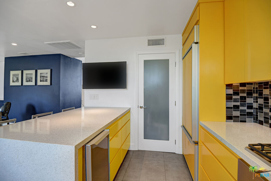 1530 North Kaweah Road Palm Springs, CA 92262 - Photo 7 of 42 a kitchen with a sink and a refrigerator