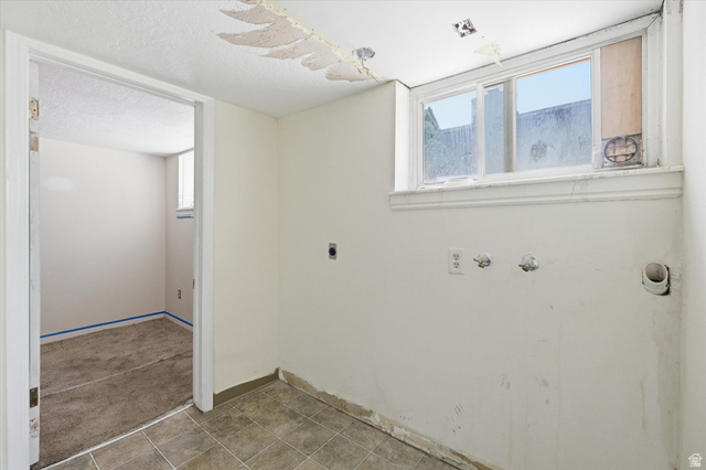 395 North 400 West Logan, UT 84321 - Photo 23 of 48 Utility space with tile flooring, a window, and exposed plumbing connections